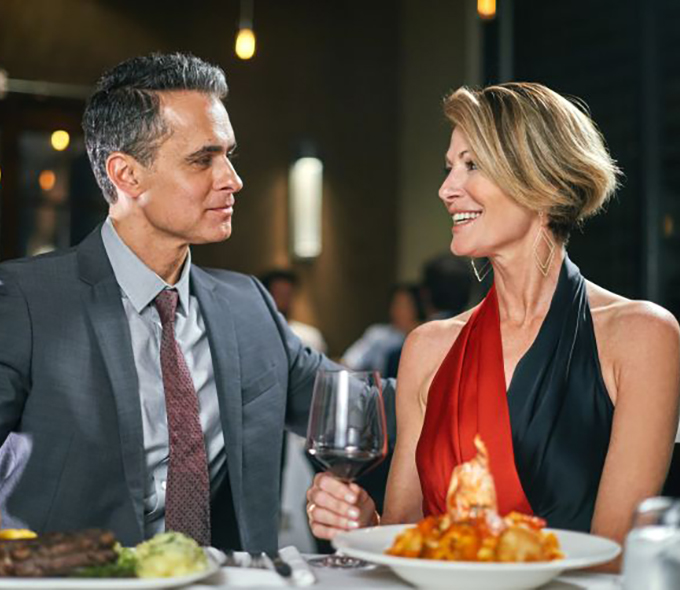 Man and Woman Looking at Each Other; Seated at a Table at Council Oak Restaurant